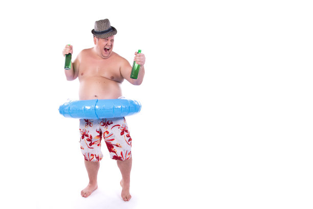 有趣的超重男人和假期。带着充气戒指的快乐男人。图片下载