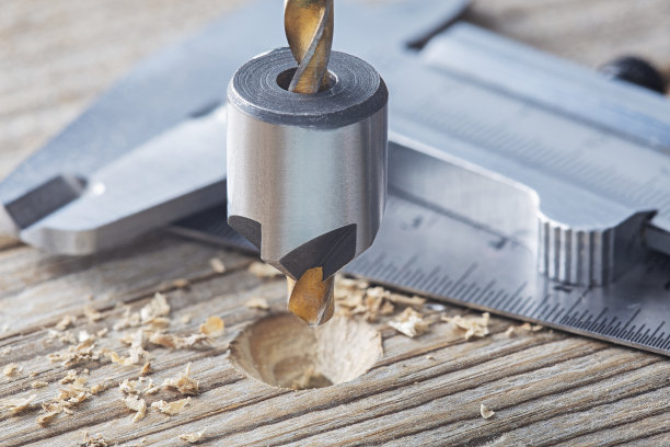 沉孔钻头用游标卡尺和直尺在旧木板上做螺丝孔沉孔图片下载