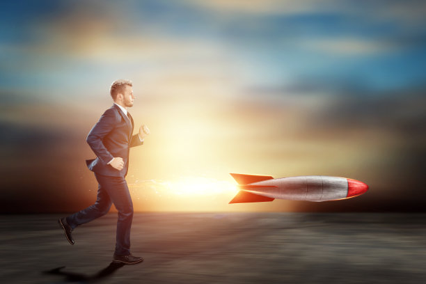 穿着商务西装的男人，一个商人正在追赶火箭。混合媒体。发展、机遇、目标、投资、愿望的概念。图片下载