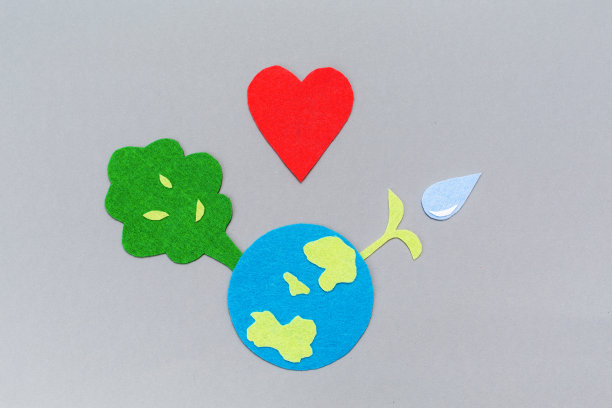 地球和树木都被剪断了，植物发芽了。副本的空间。灰色的背景。平的。地球日的概念图片下载