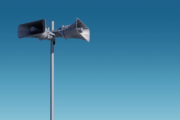 有两个灰色喇叭的金属杆顶着天空。风险预警系统。图片下载
