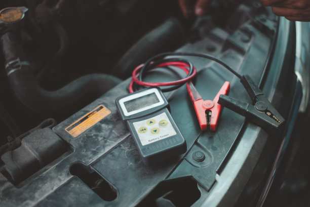 用万用表测量电压量程，检查汽车蓄电池的电压水平。测量旧汽车的电压。为秋冬做好准备。电压表用于维修汽车蓄电池图片下载