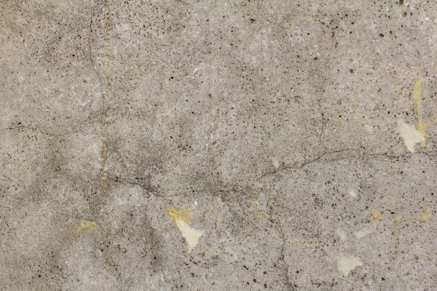 混凝土墙。抽象的纹理混凝土灰色背景。墙纸的裂缝和残余物。修理公寓或办公室。图片下载