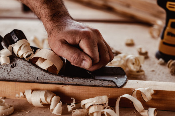 木匠的手用手刨刨一块木板图片下载