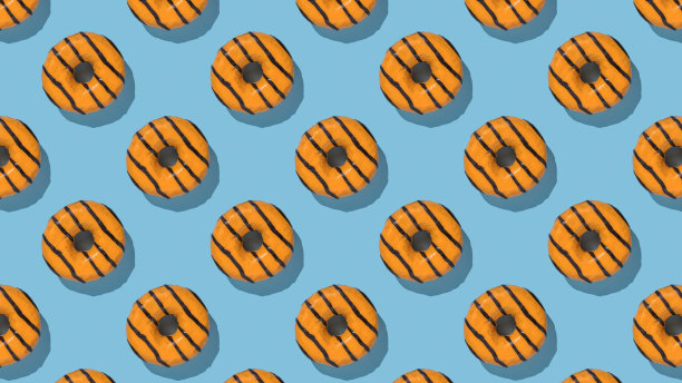 蓝色背景上釉的黄色甜甜圈图案。图片下载