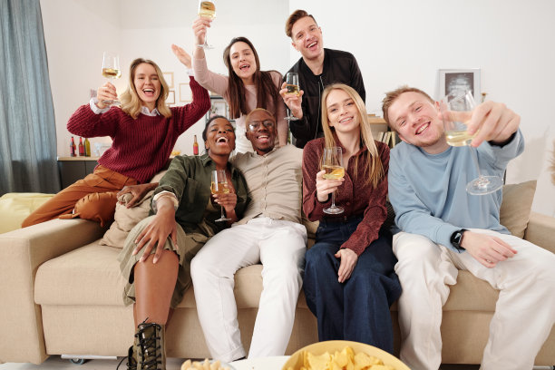 一群年轻快乐的跨文化朋友穿着时髦的休闲装坐在沙发上图片下载