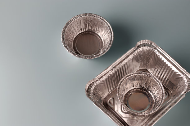 铝箔容器烹饪在一个较轻的背景。各种形状的铝箔环保盒。本空间图片下载