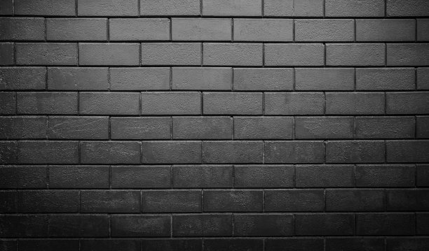 抽象的黑色砖墙纹理为图案背景进行设计。图片下载