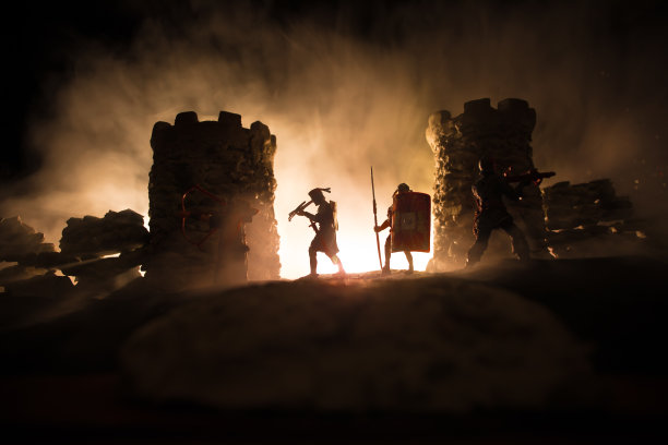 中世纪的战斗场景。剪影的人物作为单独的对象，战士之间的战斗在晚上。创意艺术品装饰。雾蒙蒙的背景。图片下载