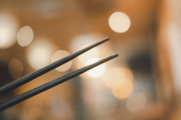 餐厅里橙色焦架上的两只黑色筷子图片下载
