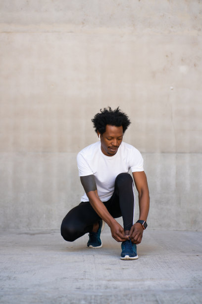 黑人运动员系鞋带。图片下载