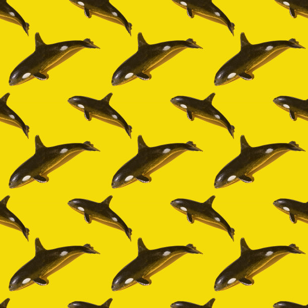 无缝模式与鲨鱼形状的鱼饵在黄色的背景。2021年的颜色。前视图。图片下载