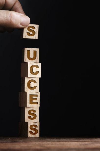 成功写在木制玩具积木上，黑色的背景图片下载