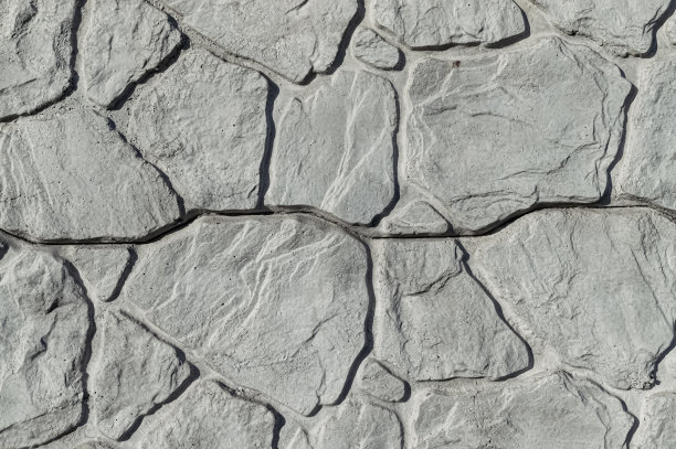 灰色的石墙背景与浮雕。图片下载