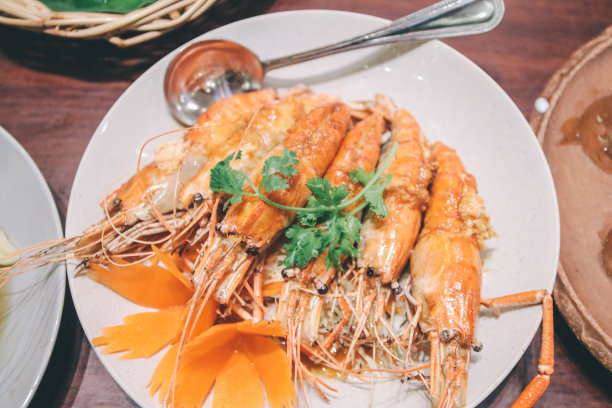 罗望子酱炸虾仁。受欢迎的泰国菜。这道菜里有5只虾，上面淋了酱汁。这些蔬菜是香菜图片下载