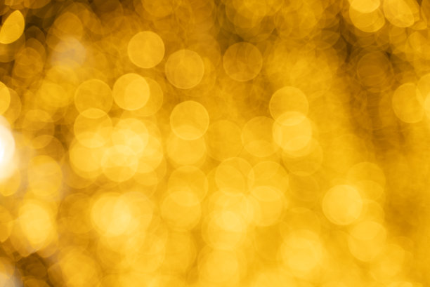 抽象模糊的散景夜灯背景，圣诞派对背景，模糊的图案在金色明亮闪亮，散焦迪斯科照明设计图片下载