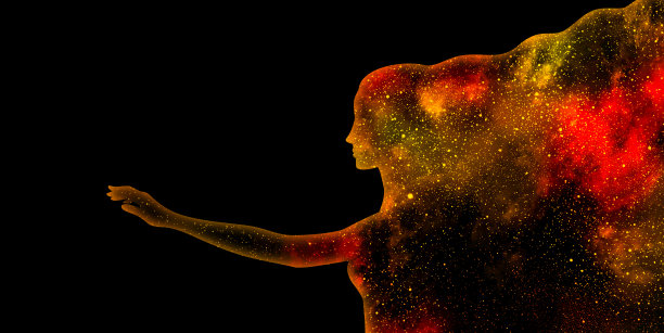红色和黄色闪烁的恒星宇宙在一个女人的侧面剪影伸出手在黑色的背景图片下载