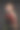 一个戴着墨镜的年轻女子的画室肖像，以黑色为背景，手里拿着一束红色郁金香图片下载
