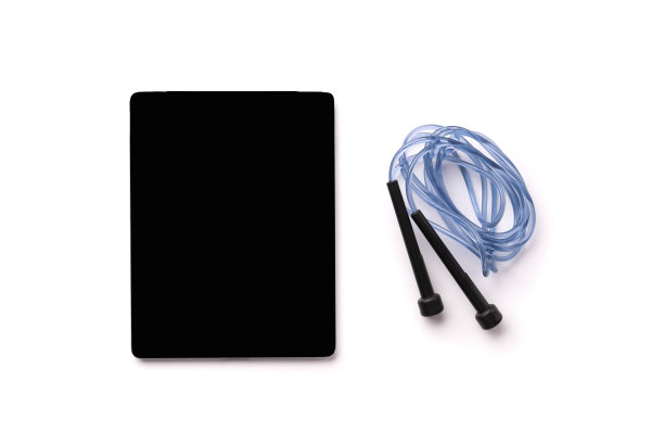 平躺俯视图跳绳和平板与空白屏幕上的白色背景图片下载