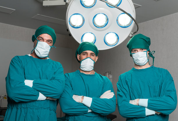 专业外科医生肖像，双臂交叉，看向镜头，医疗团队在医院手术室进行手术图片下载