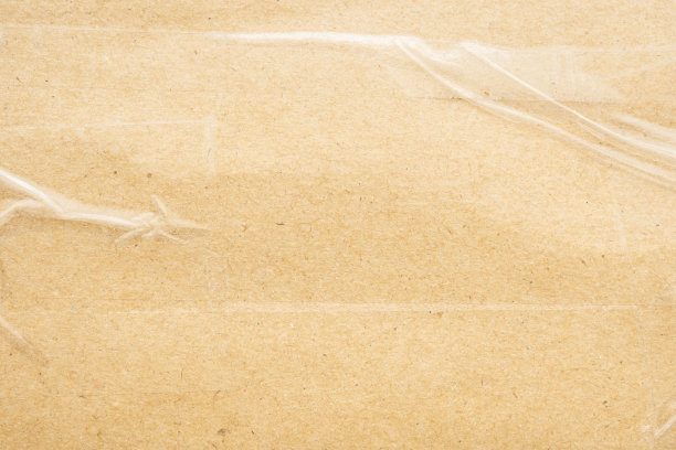 透明胶带上的旧棕色硬纸板纸背景图片下载