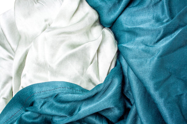 柔和的橄榄绿和绿色缎子织物背景。织物折叠图片下载