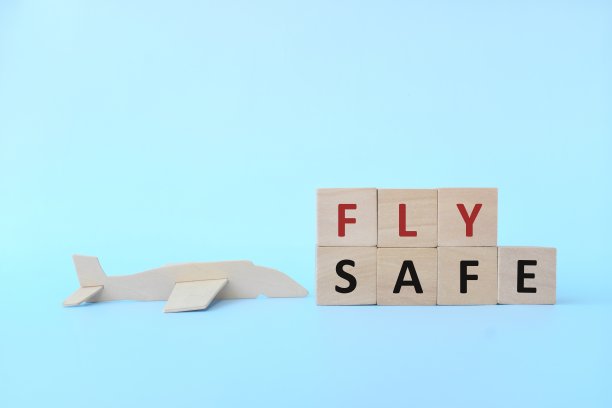 木制飞机模型与天蓝色的背景块。飞行和旅行的安全概念。图片下载