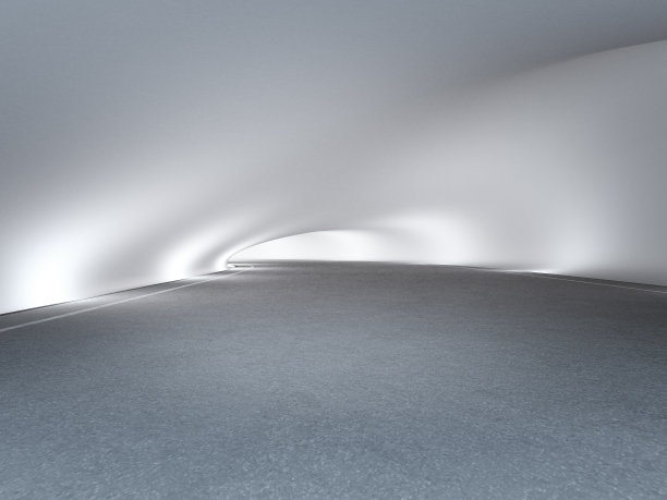 隧道或展厅内的沥青路面和弯曲的混凝土墙背景。图片下载