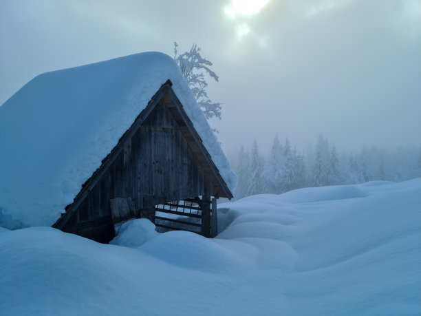 山上的小屋笼罩在薄雾中图片下载