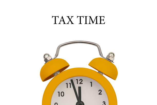 白色背景上的黄色闹钟。该交税了。提醒纳税或年度纳税图片下载