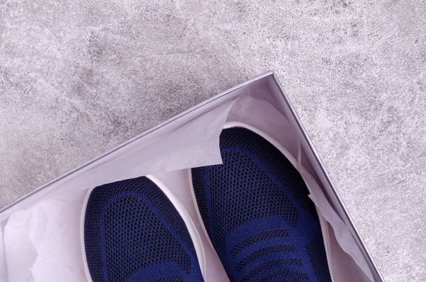 编织的蓝色运动鞋没有鞋带在灰色的背景。图片下载