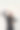 好玩的年轻女人穿着黑色的衣服看起来内容，拿着塑料信用卡在她的眼睛，而摆出孤立的灰色背景图片下载
