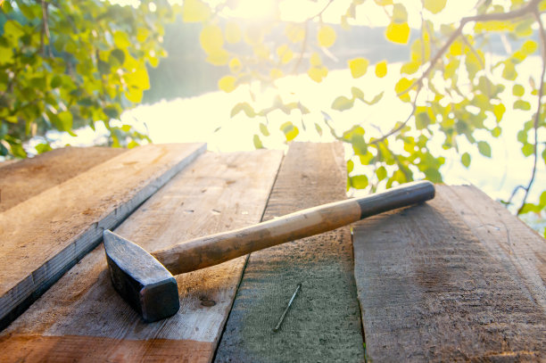 用锤子和钉子钉木板。太阳耀斑图片下载