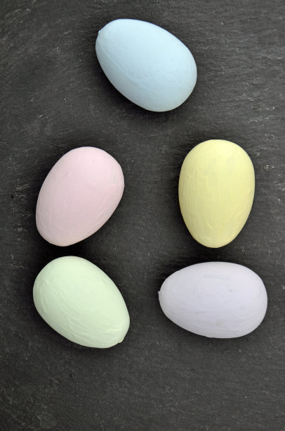 五只彩色复活节彩蛋放在深灰色的石板上图片下载