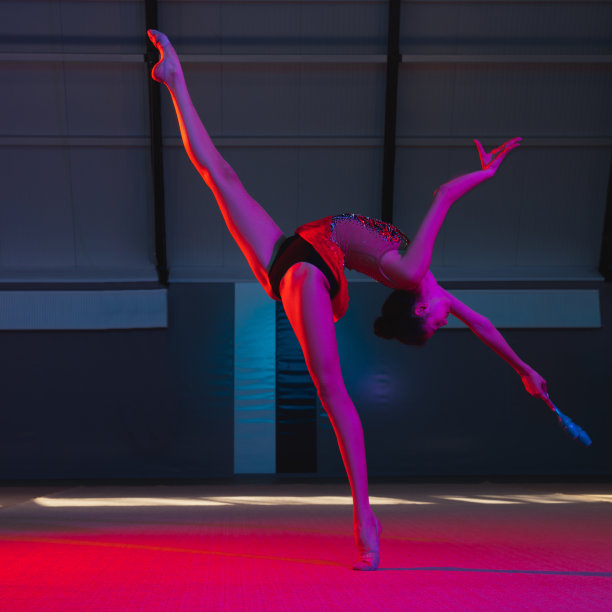 优雅的白人女子体操运动员在霓虹灯的彩色背景下孤立图片下载