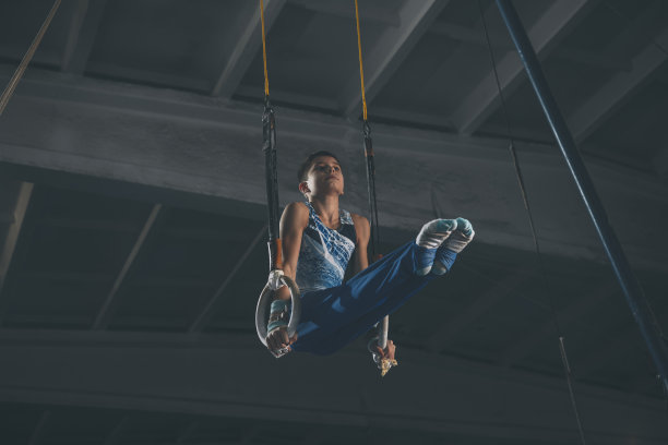 小男子体操运动员在体操馆里训练，灵活、活跃。白种人健康的小男孩，运动员穿着运动服练习力量，平衡。图片下载