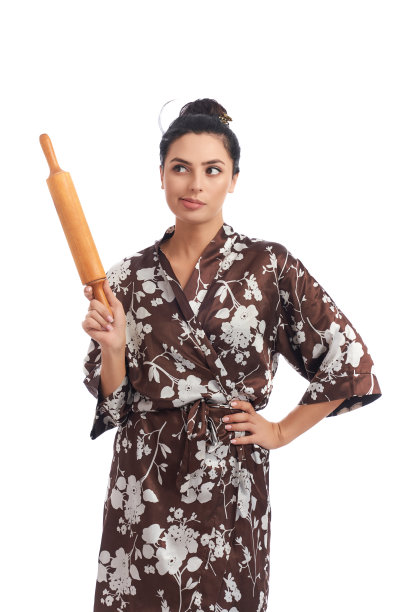 家庭主妇穿着家庭长袍，手拿擀面杖图片下载