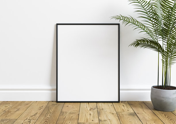 单8x10垂直黑色框架模型与绿色植物在木地板和白色墙壁。图片下载