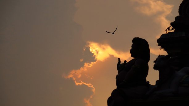 日落时印度教雕像的剪影图片下载