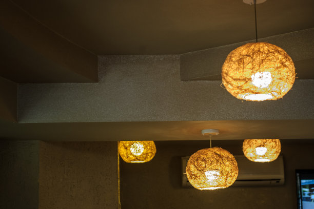 这是餐厅大厅金色天花板上悬挂的丝线灯的照片图片下载