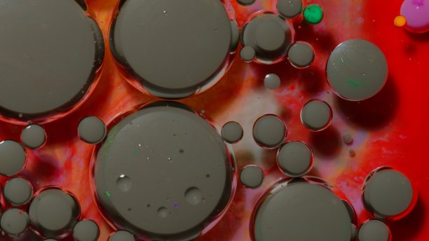 明亮的霓虹灯彩色气泡油和墨水，丙烯酸漆移动特写，壁纸背景图片下载