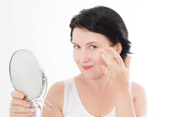 美丽的中年女人用镜子。面对肖像。Spa和抗衰老概念隔离在白色背景上。整形手术和胶原蛋白脸部注射。皱纹和更年期。模拟。本空间图片下载