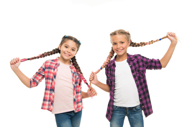 的乐趣。叛逆的精神。学校风格的发型。女孩长辫子。时尚的趋势。时尚漂亮的女孩。快乐的童年。保持头发编织。姐妹们梳着长长的辫子。理发师沙龙图片下载