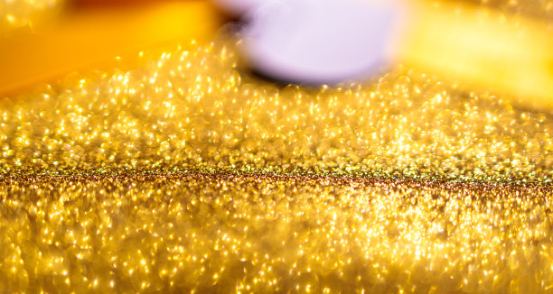 模糊的金色背景与金色丝带背后图片下载