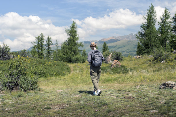 徒步女走在夏秋的自然背景在秋天的季节。徒步活动的人概念。图片下载