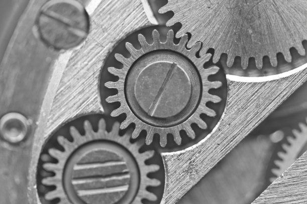 黑白背景与金属齿轮的旧发条。成功的商业设计概念照片。宏。图片下载