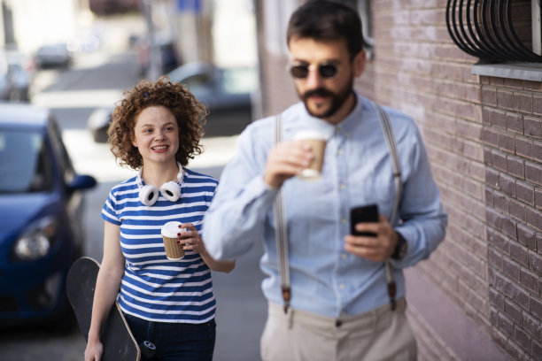 快乐的女人和男人走在城市里。库存图片图片下载