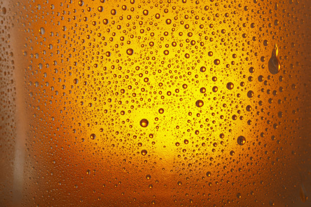 啤酒的背景。冰镇啤酒杯与水珠凝结图片下载