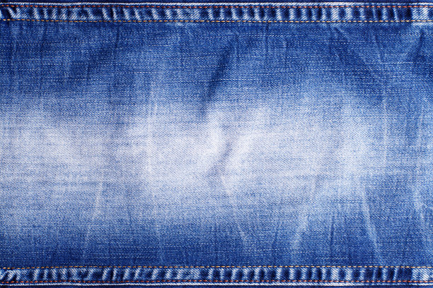 蓝色牛仔裤纹理与接缝接近，在牛仔纺织背景上缝线，蓝色牛仔背景，褪色的牛仔裤图案，破旧的靛蓝牛仔布，垃圾织物，旧的复古材料，复制空间图片下载