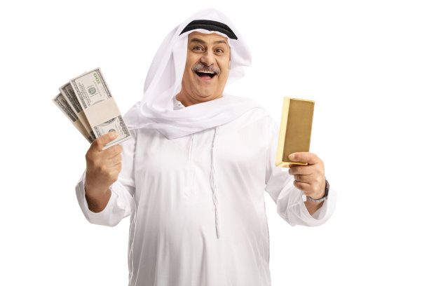 成熟的阿拉伯男人拿着金条和钱图片下载